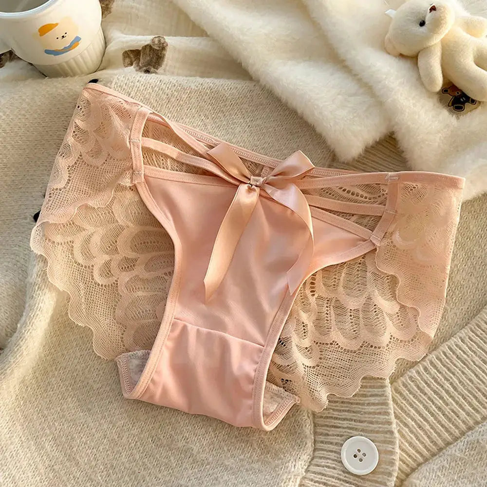 Women's pink lace panties with satin bow, mid-low rise, cotton gusset, breathable design.