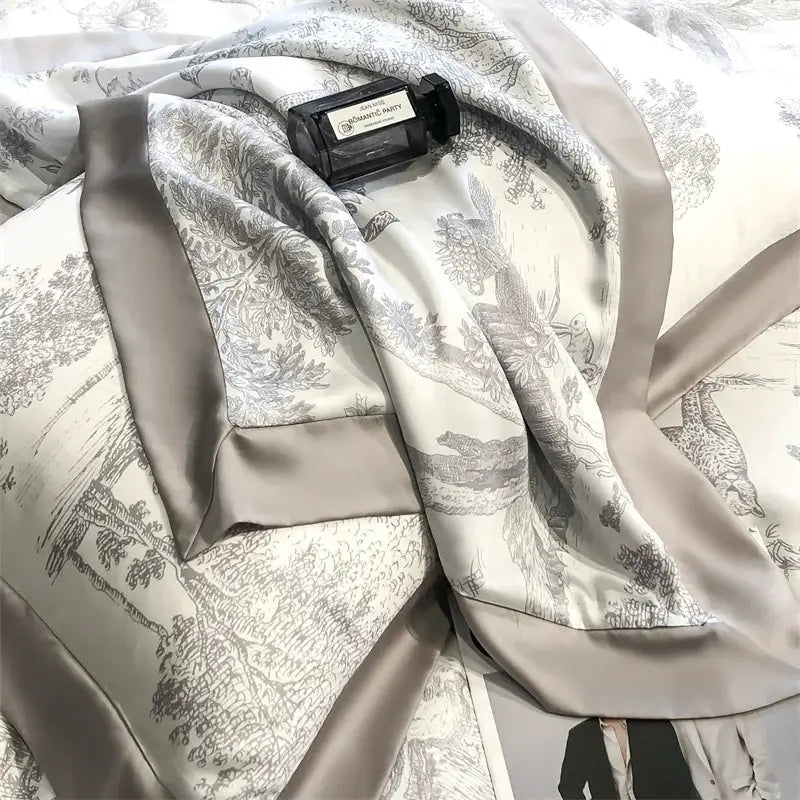 Lyocell bedding set with forest leopard motif; duvet cover, sheet, and pillowcases in silver-gray with taupe satin trim.