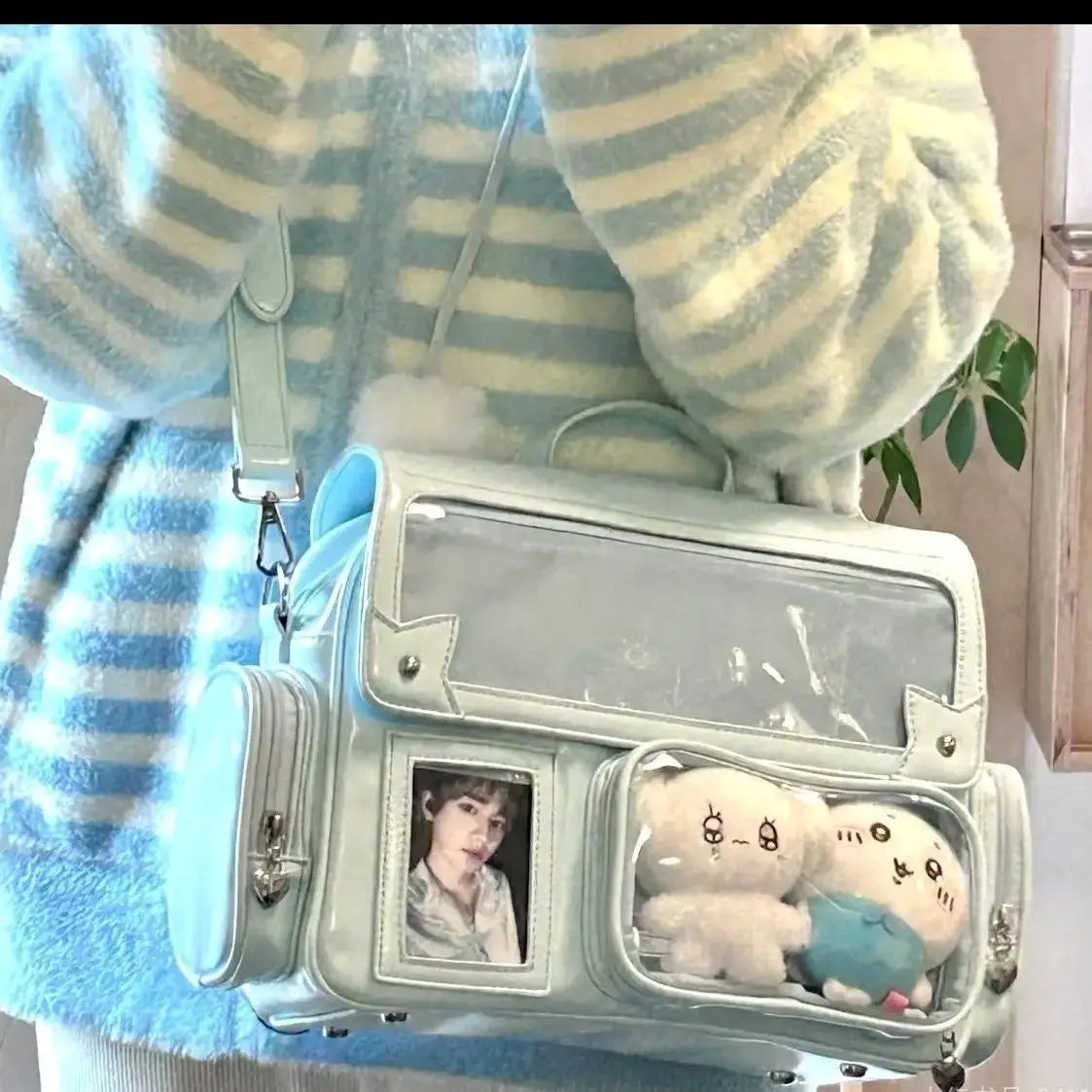 Simples Market light-blue leather Ita bag backpack with clear front panel and photo slot.