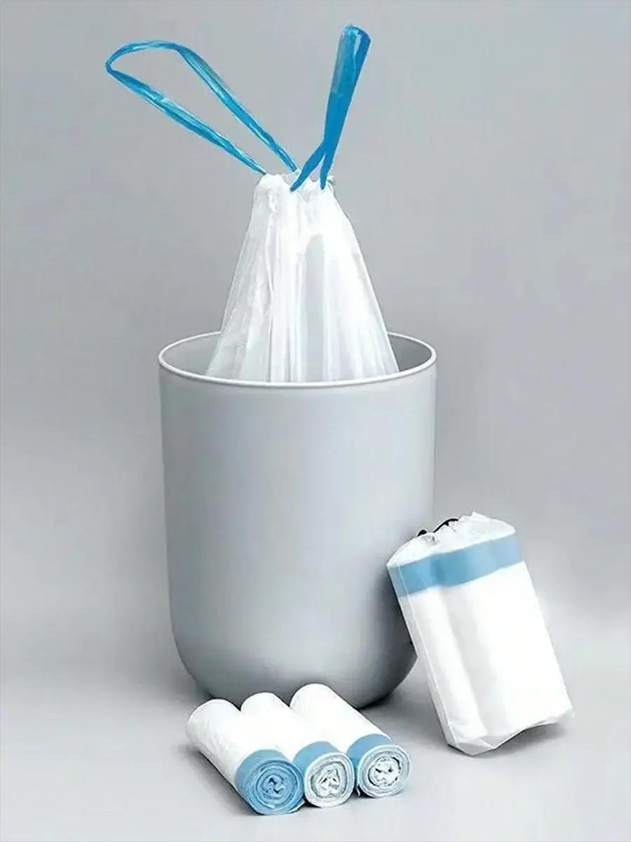 Thick white trash bags with tear-off blue drawstring, 15pcs per roll, shown with rolls beside a gray trash can