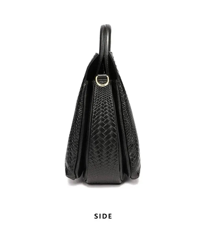 Women's black woven cowhide handbag with top handle and gold ring detail