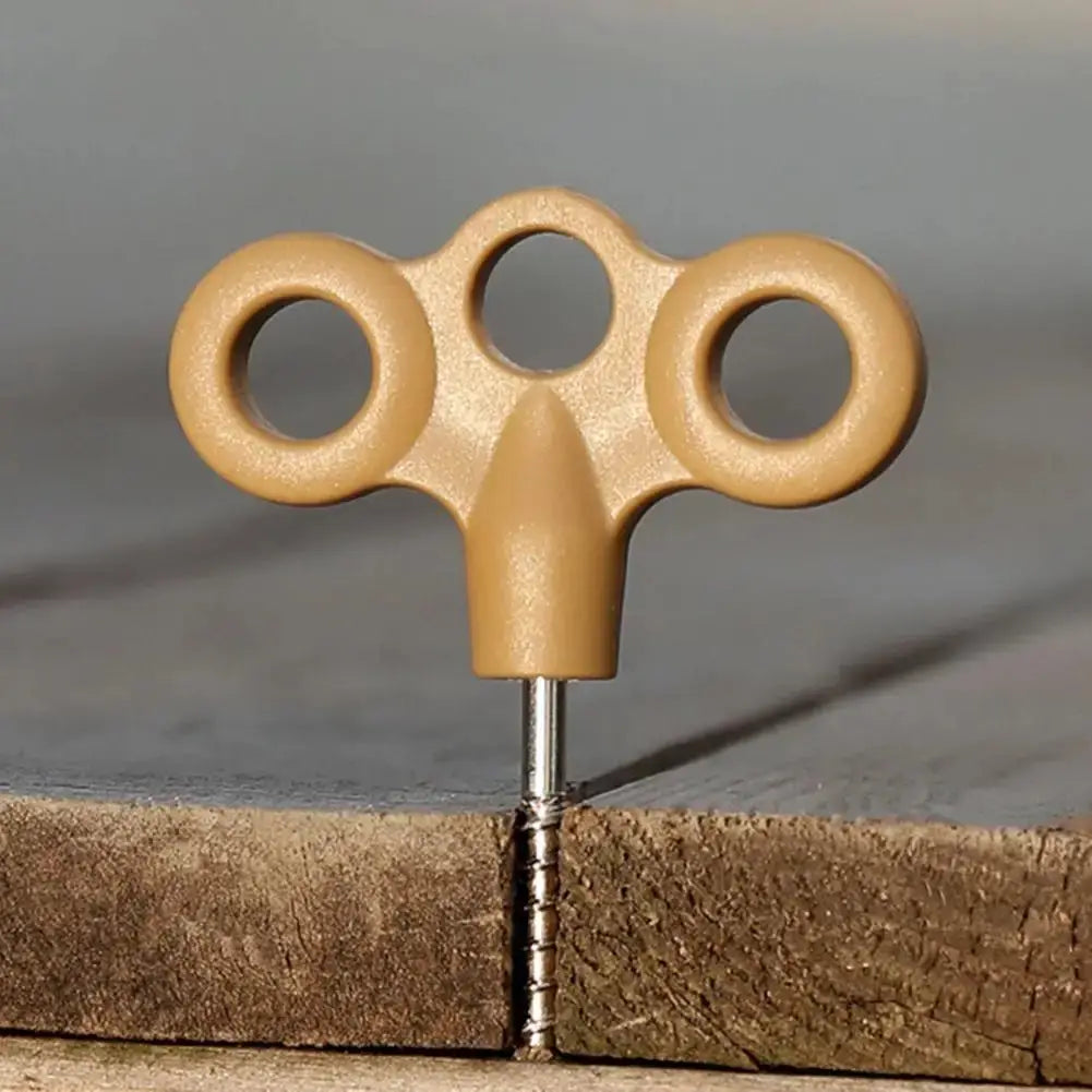 Ground anchor with tan triple-ring head and metal screw shaft for outdoor use