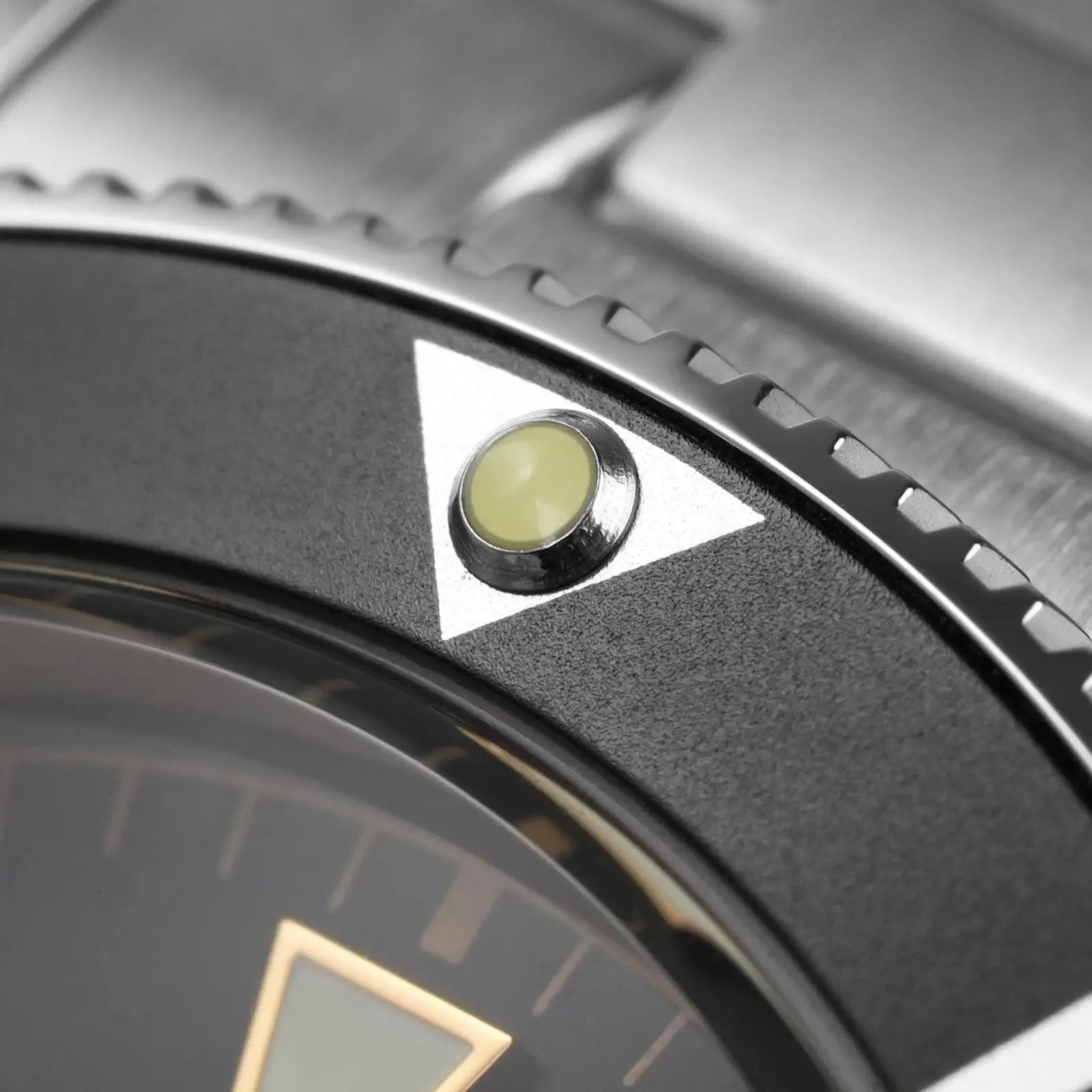 Watchdives WD7922 BB54 watch bezel close-up with a luminous yellow pip inside a triangle marker