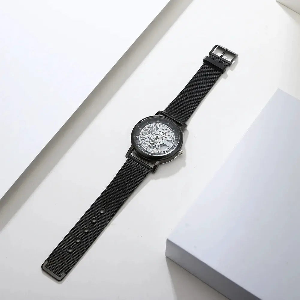 Women's hollow skeleton watch with black metal mesh band and visible gears
