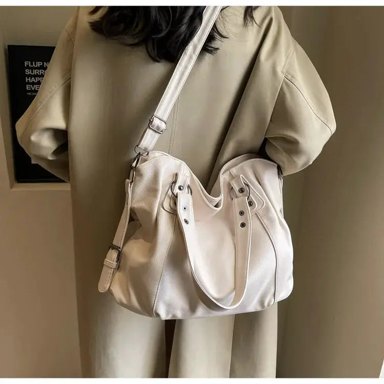 Soft interior shoulder bag by Simples Market in cream PU leather with two top handles and crossbody strap
