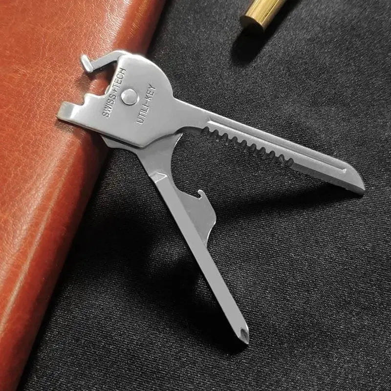 6-in-1 folding multitool keychain by Simples Market in silver with bottle opener and screwdriver tips.