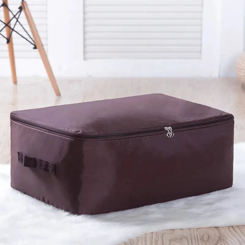 Large dark brown zipper clothes organizer bag for bedding storage with side handles.