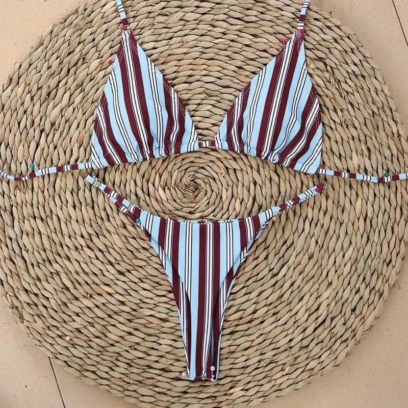Simples Market micro bikini set with maroon, light blue and white stripes; triangle top and thong bottom on woven mat