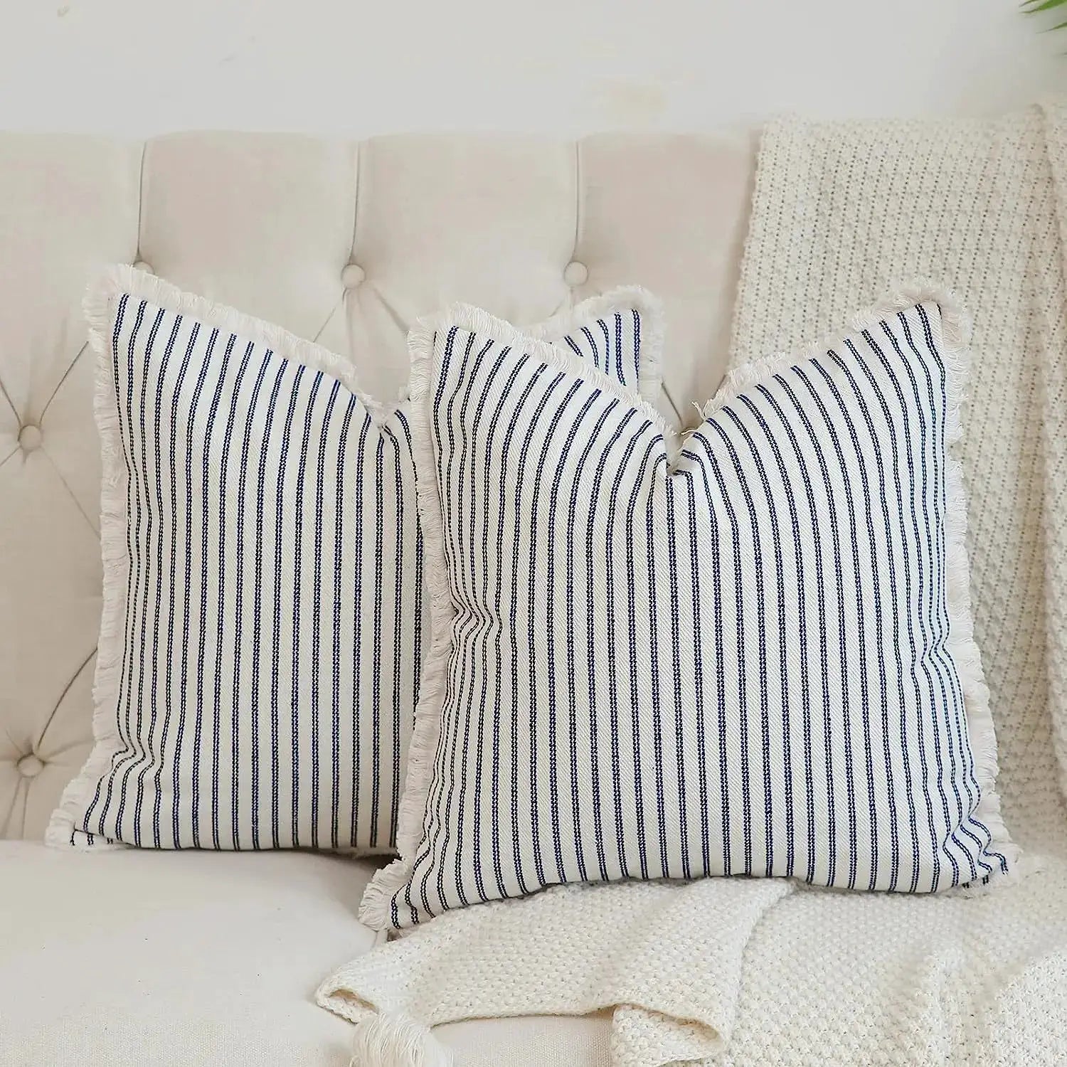 Wool striped cushion cover by Simples Market; square, fringed edges, navy stripes, set of 2 on beige sofa.