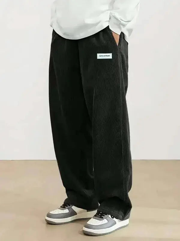 Men's black corduroy casual pants by Simples Market, loose-fit with elastic drawstring waist.