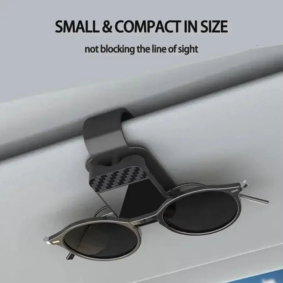 Car sun visor clip with card holder; black clip holding round-frame sunglasses with silver frames