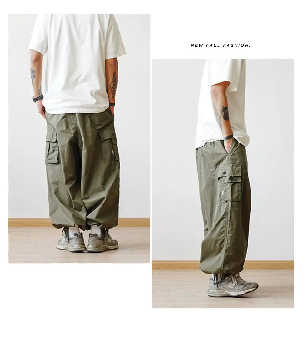 Multi-pocket cargo pants; olive green, oversized wide-leg with ankle cuffs.