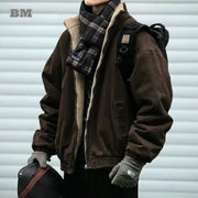 Men's brown polar fleece jacket with cream sherpa lining, paired with plaid scarf and backpack