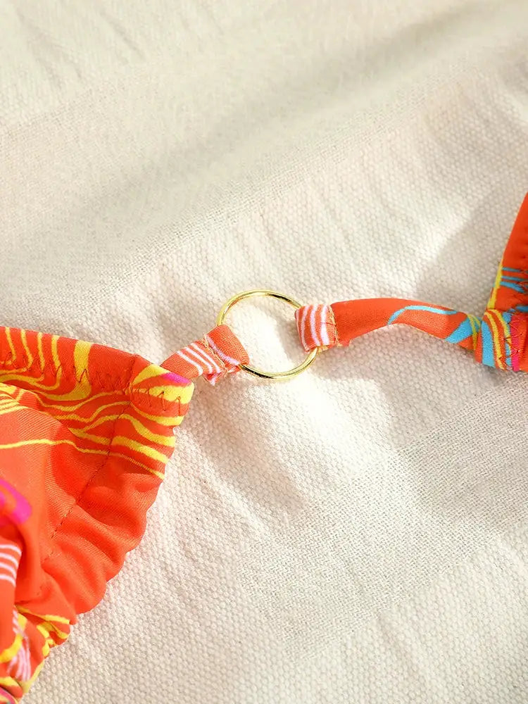 Triangle bikini top with gold ring connector in bright orange printed fabric