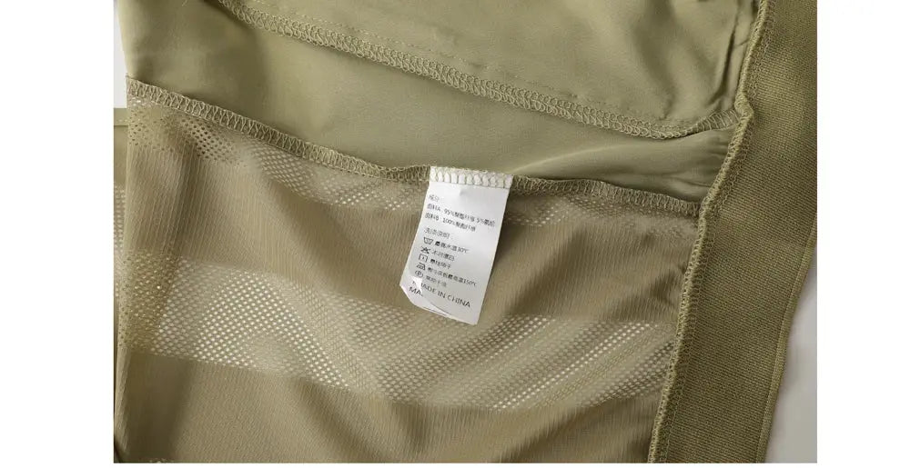 Summer men's mesh breathable vest inside view, khaki fabric with care tag