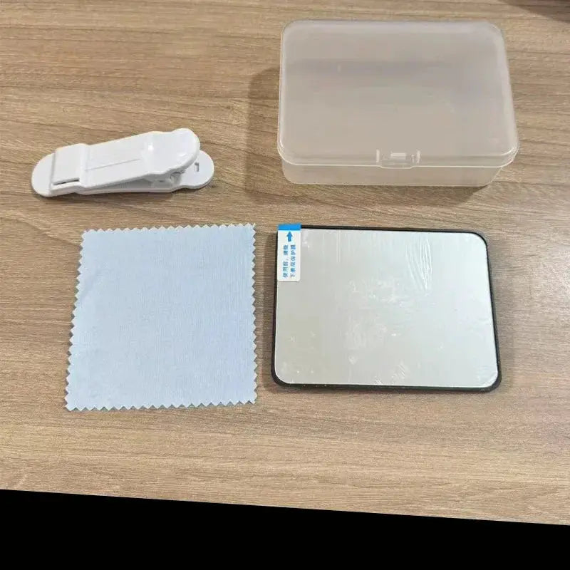 Portable mobile phone camera reflector kit with mirror panel, white clip, blue microfiber cloth, and clear storage case