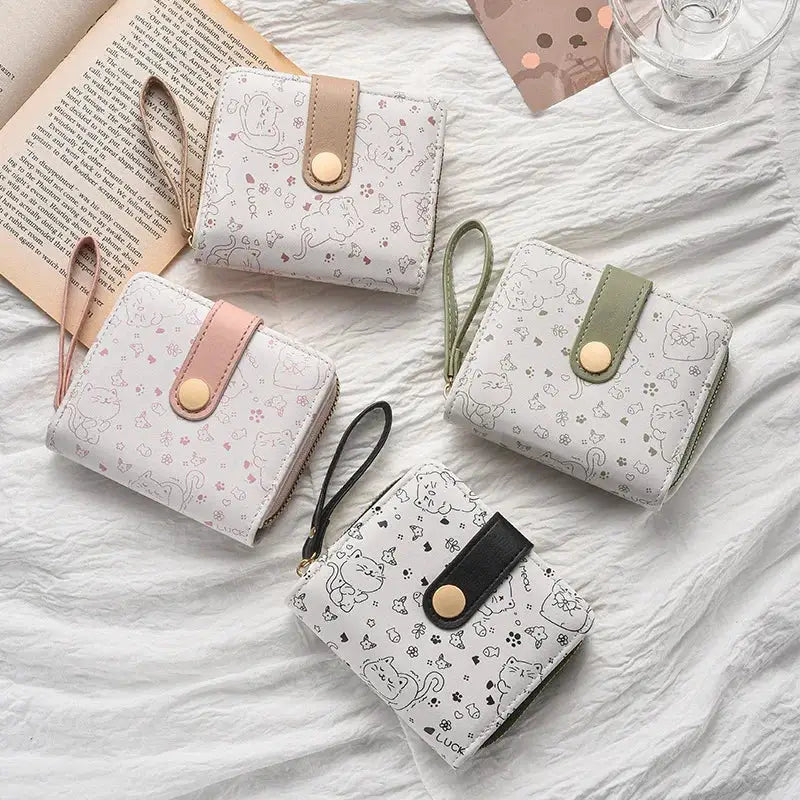 Cat-pattern wallet set with straps: four compact zipper wallets in pink, beige, green, and black.