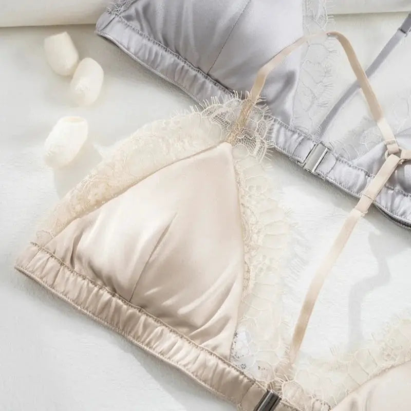 Two lace bralettes in beige silk and gray satin with lace trim