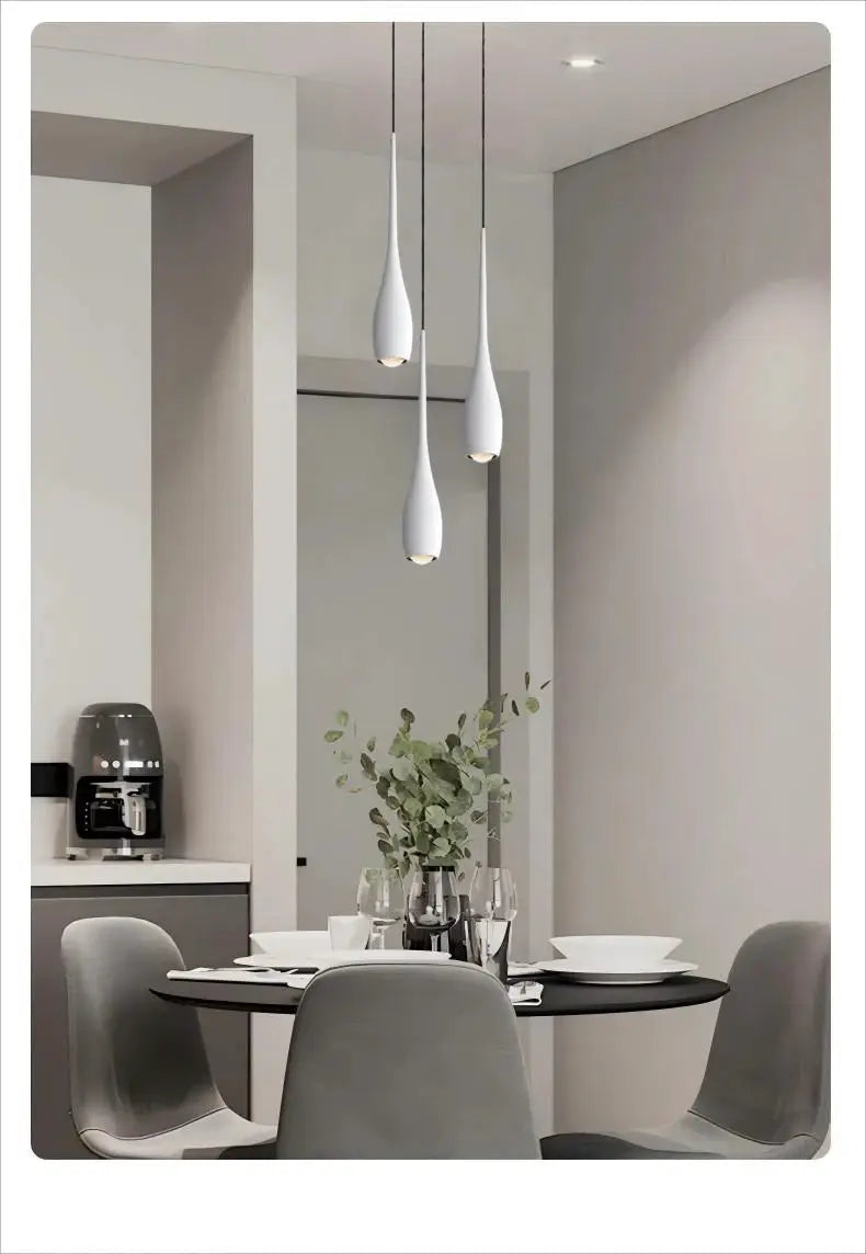 MARPOU LED pendant lights, 3 white teardrop fixtures hanging over a round dining table in a modern minimalist kitchen.