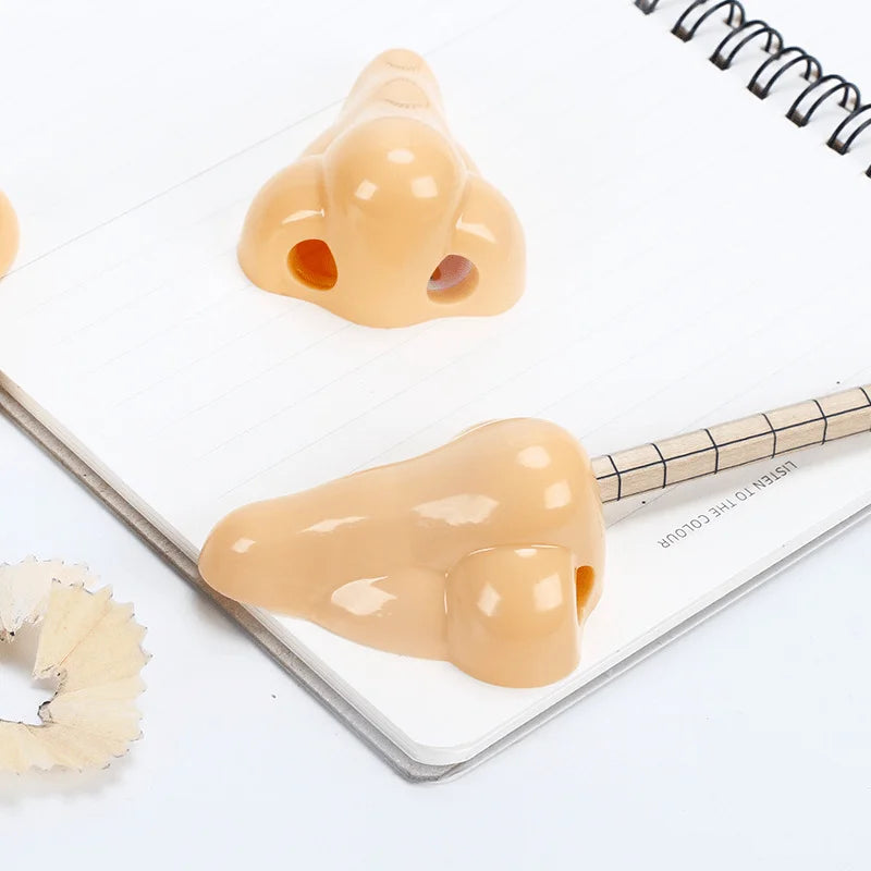 Simples Market nose-shaped pencil sharpeners, peach-colored, 2 pcs on notebook pages