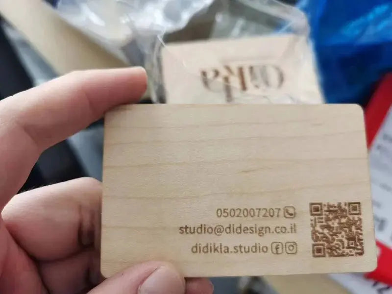 Wooden NFC card with laser-engraved contact info and QR code