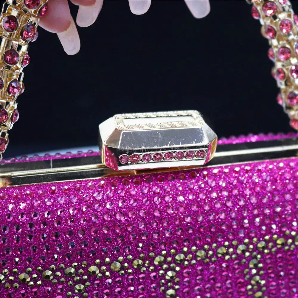 Pink rhinestone evening clutch with diamond-style embellishments and a long chain strap.