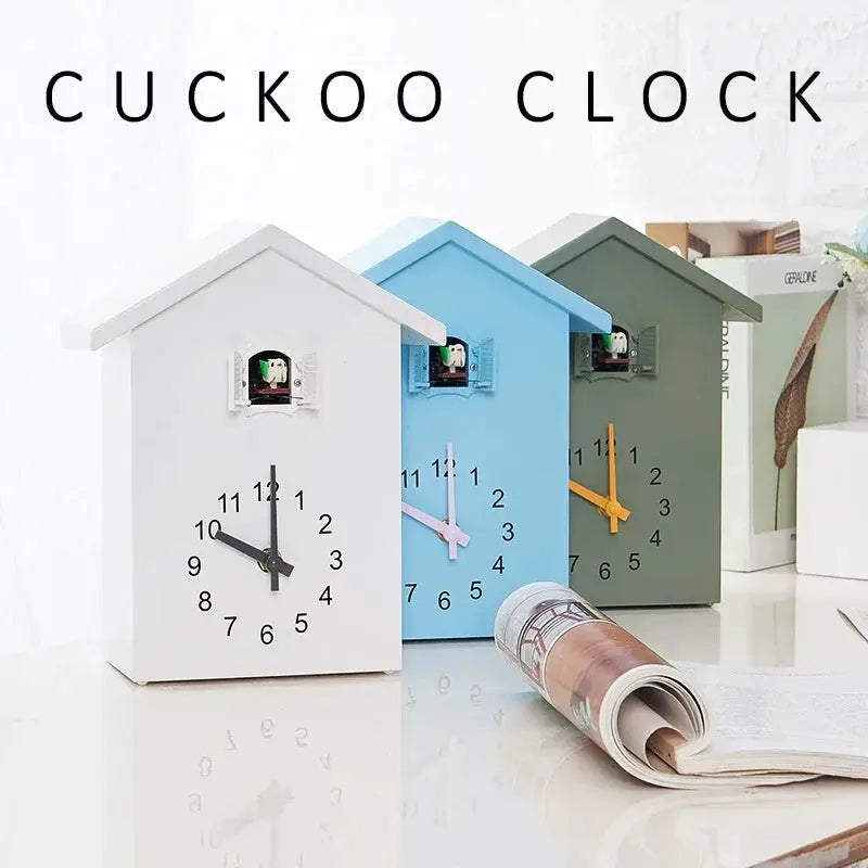 Cuckoo quartz wall clocks; 3 house-shaped clocks in white, blue and green with contrasting hands