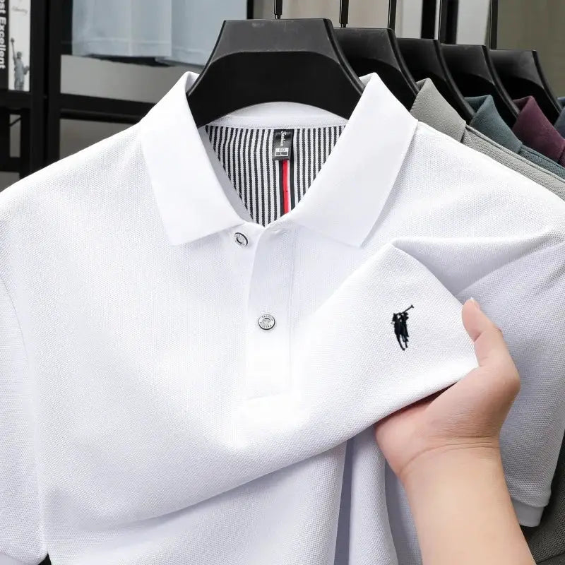 White cotton polo shirt, short-sleeve, with small black polo-player embroidery on left chest.