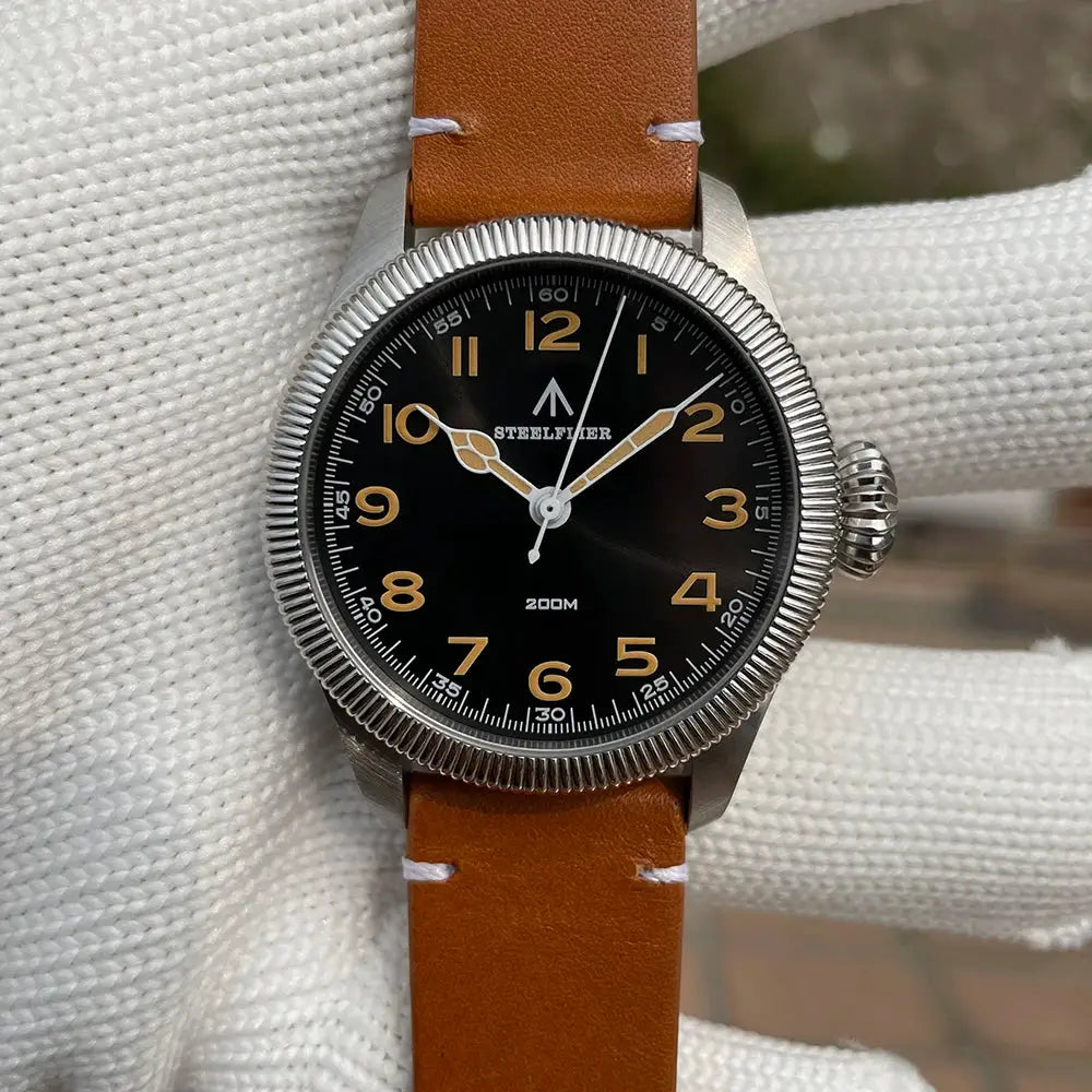 STEELFLIER SF741 wristwatch with black dial, tan leather strap, gold numerals, silver bezel, 200M waterproof