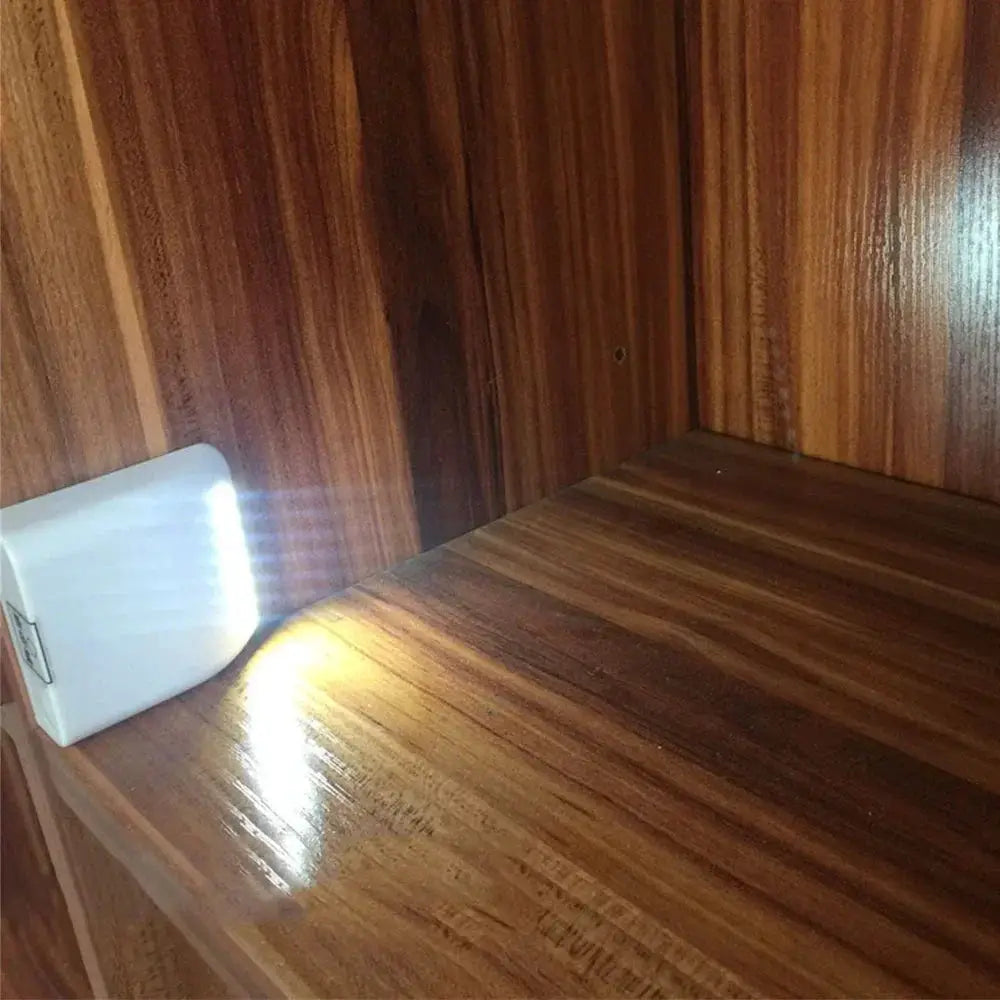 Simples Market LED cabinet light, white wireless motion sensor lamp mounted inside wooden wardrobe.