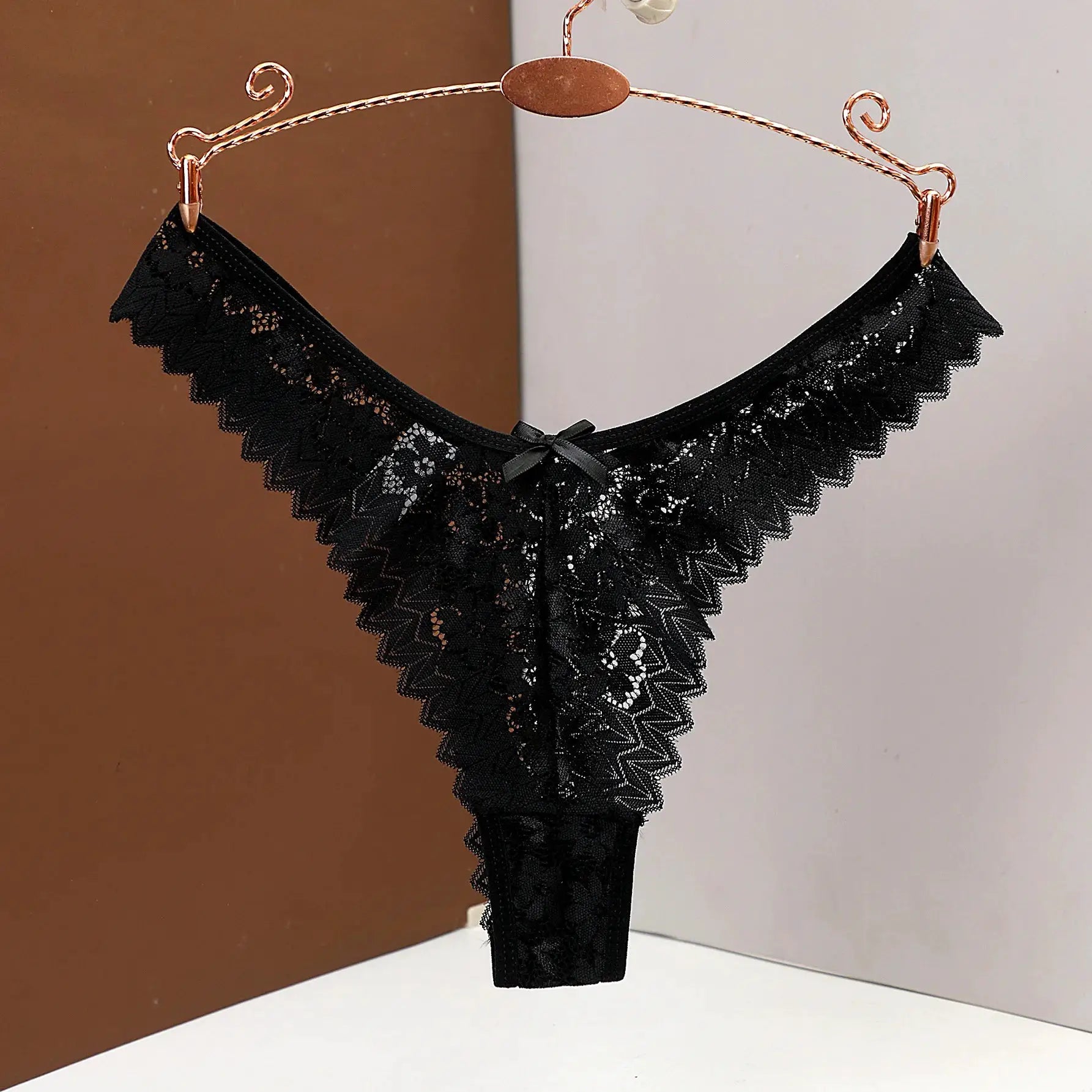 Women's black lace thong underwear by Simples Market with scalloped low-waist lace trim