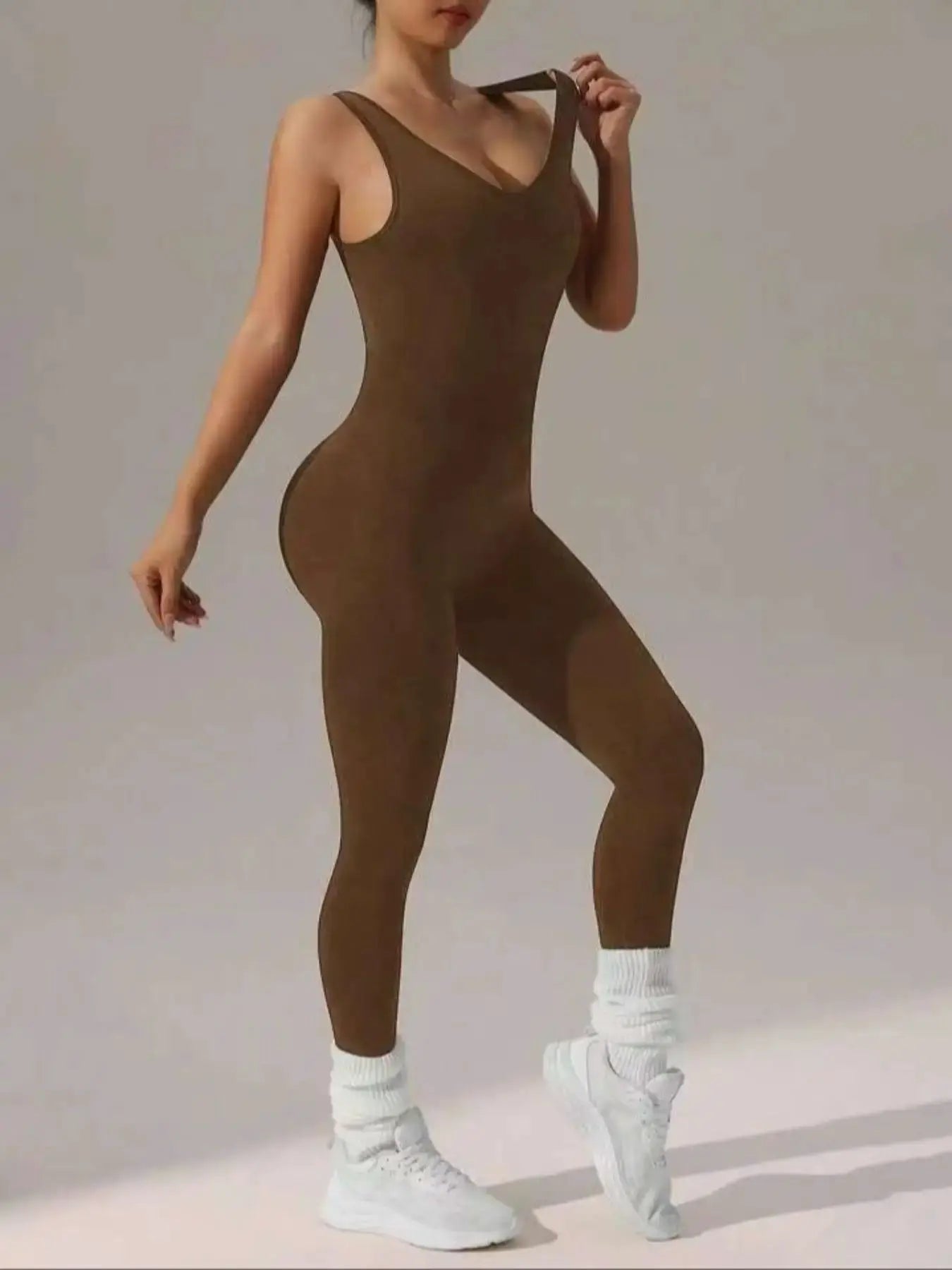 Women's brown sleeveless vest jumpsuit with elastic fit, form-fitting yoga-style one-piece