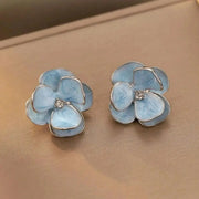 Blue enamel flower earrings with silver-tone edging and center crystals; pair
