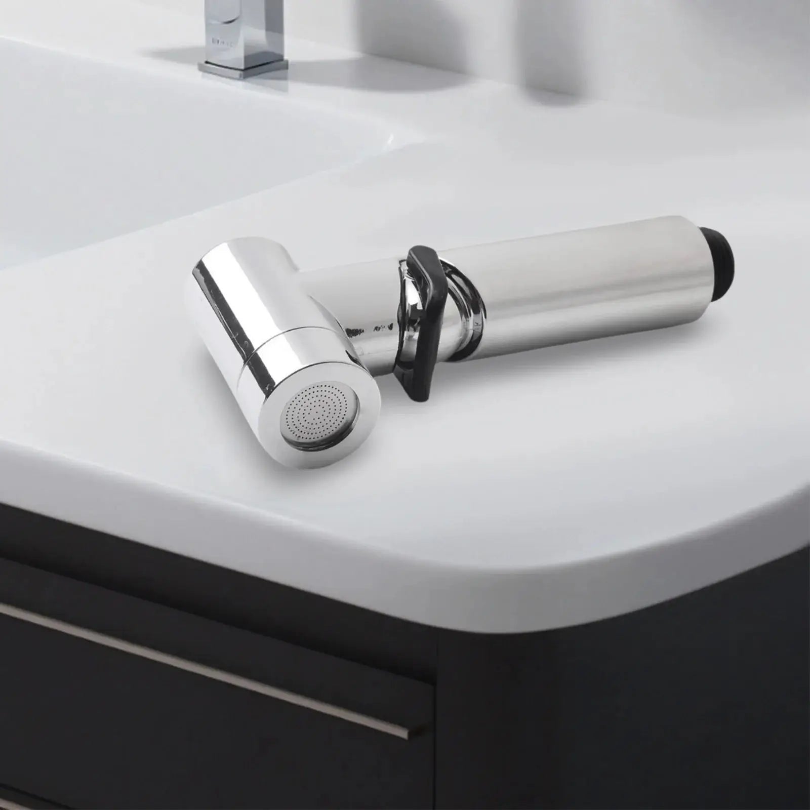 Handheld ABS chrome bidet spray head with black lever on bathroom sink counter