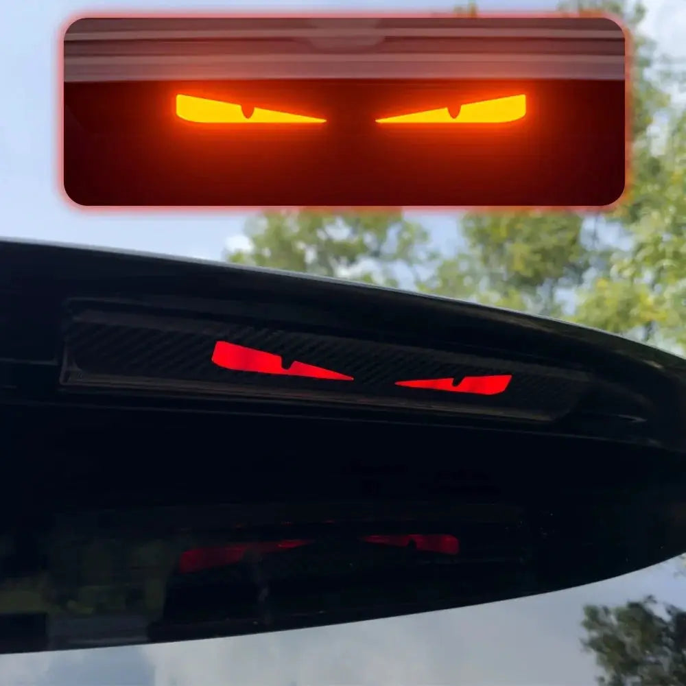 Monster Eyes car rear light sticker with cartoon devil eyes, red glow and carbon fiber pattern