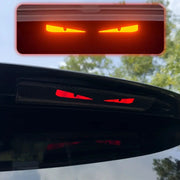 Monster Eyes car rear light sticker with cartoon devil eyes, red glow and carbon fiber pattern
