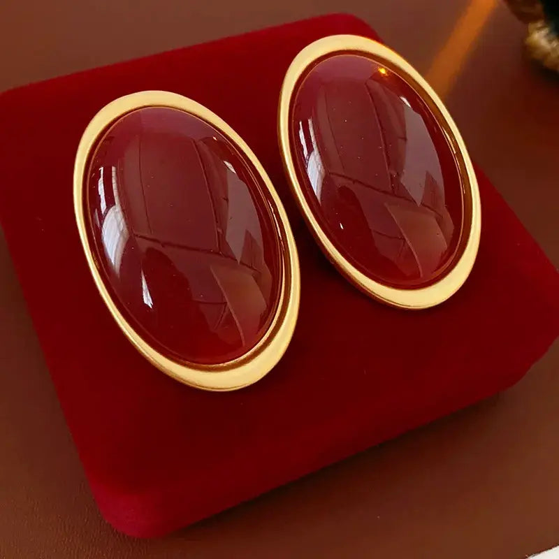 Vintage red resin oval earrings with gold-tone frame; large geometric studs for party or wedding.