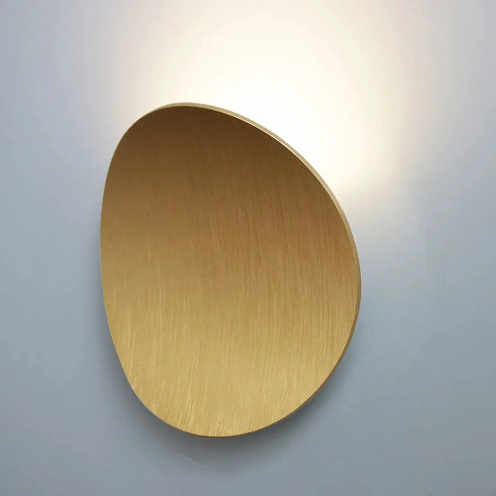Round LED wall lamp in brushed gold aluminum with a modern minimalist design