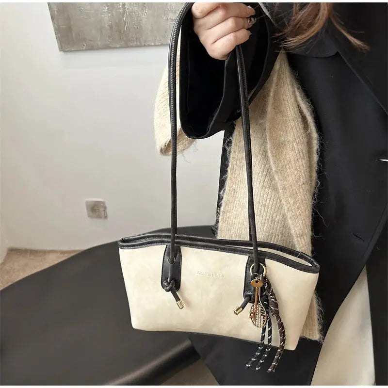 European American retro tote bag by Simples Market; beige body with black trim, long shoulder straps and pendant charm.