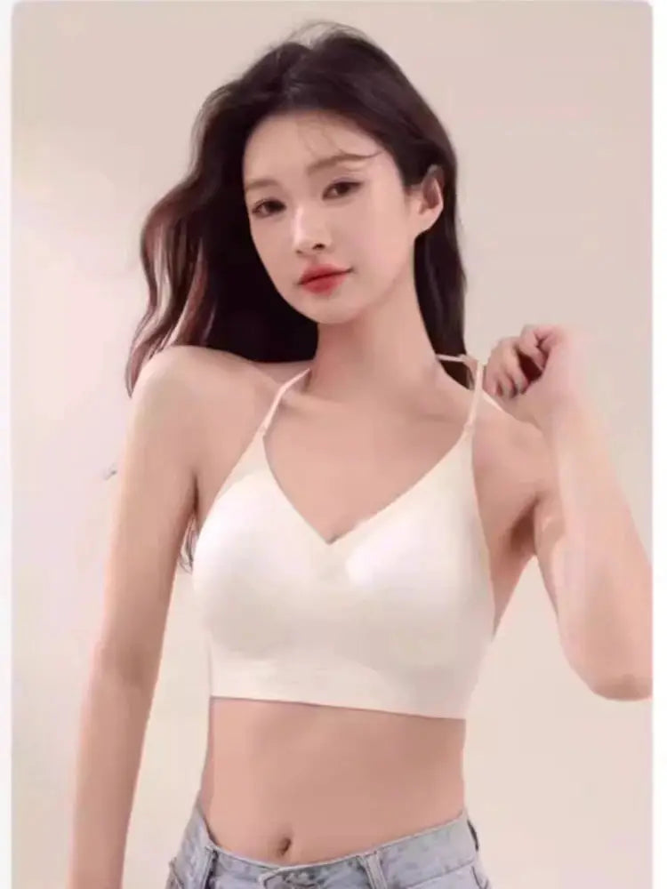 White seamless bralette with thin straps, V-neck, no underwire worn by a model.
