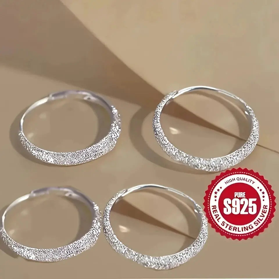 Sterling silver circle hoop earrings for women with frosted, sparkling texture; set of four.