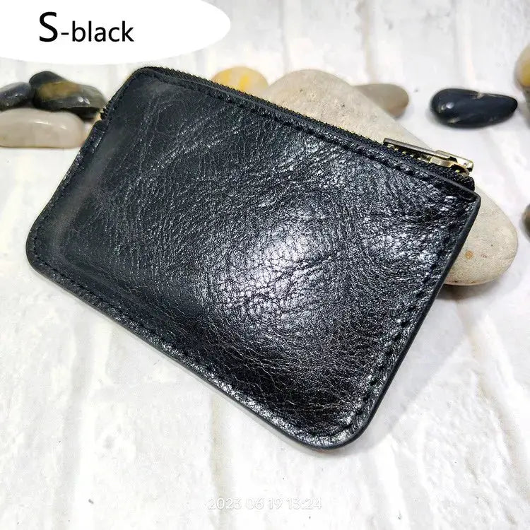 Mini zipper waist bag in black leather by Simples Market; compact belt-pack for IDs, cards, passport and phone.