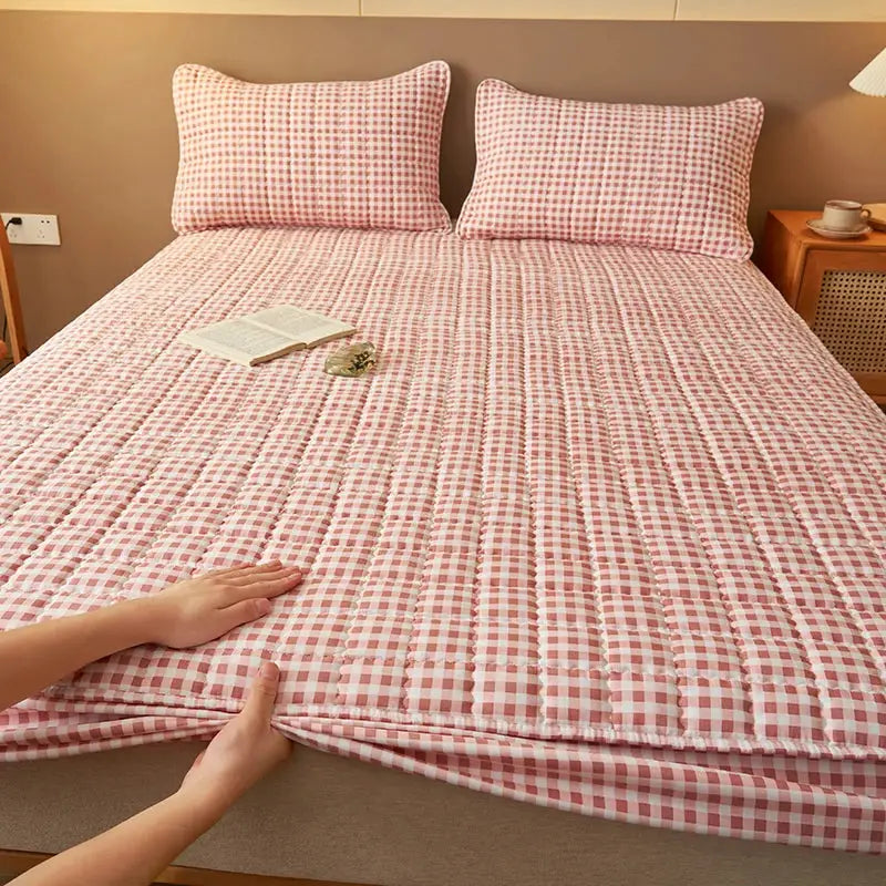 Quilted plaid mattress protector in pink and white, antibacterial and breathable