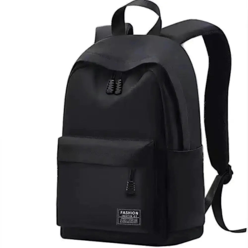 Backpack, black, minimalist with front zip pocket and top handle.