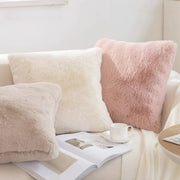Plush soft faux-fur pillow covers in ivory, cream and blush pink on a cozy sofa set of 3 for warm decor.