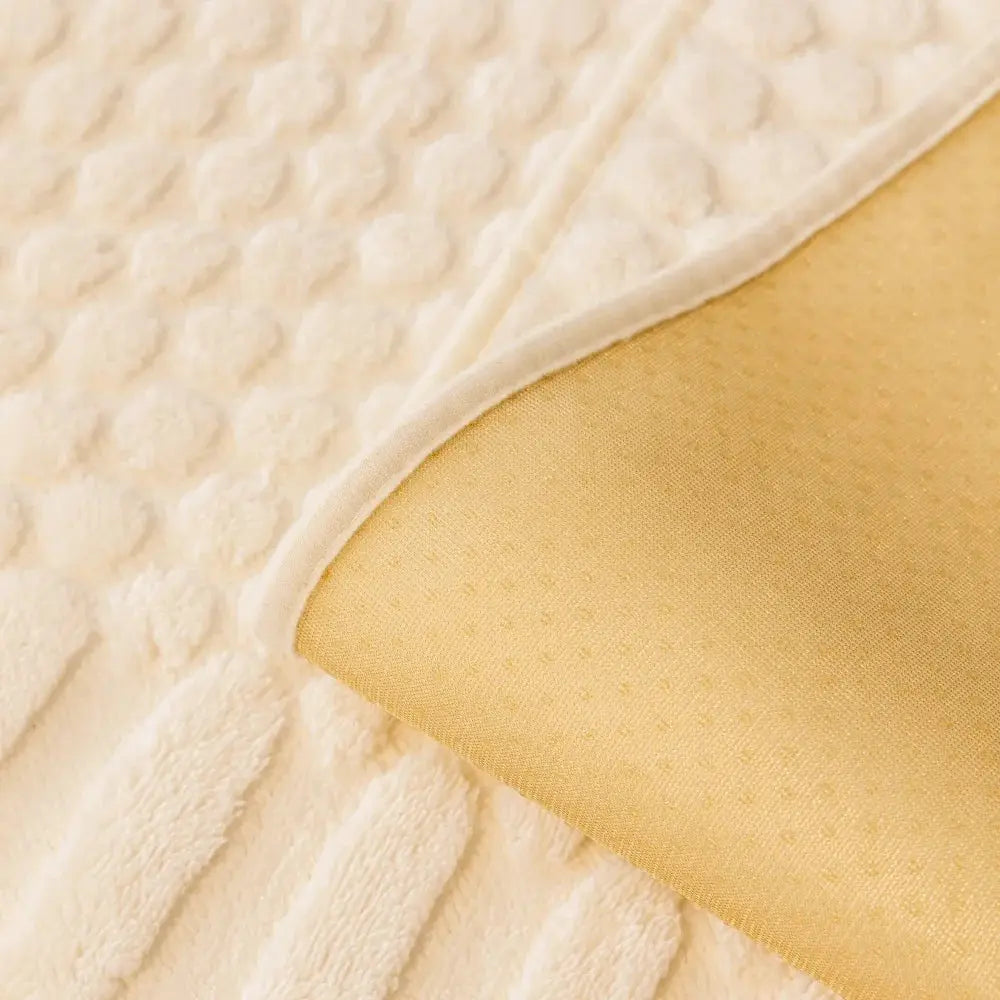 Sofa cover in beige geometric jacquard fleece with anti-slip backing by Simples Market