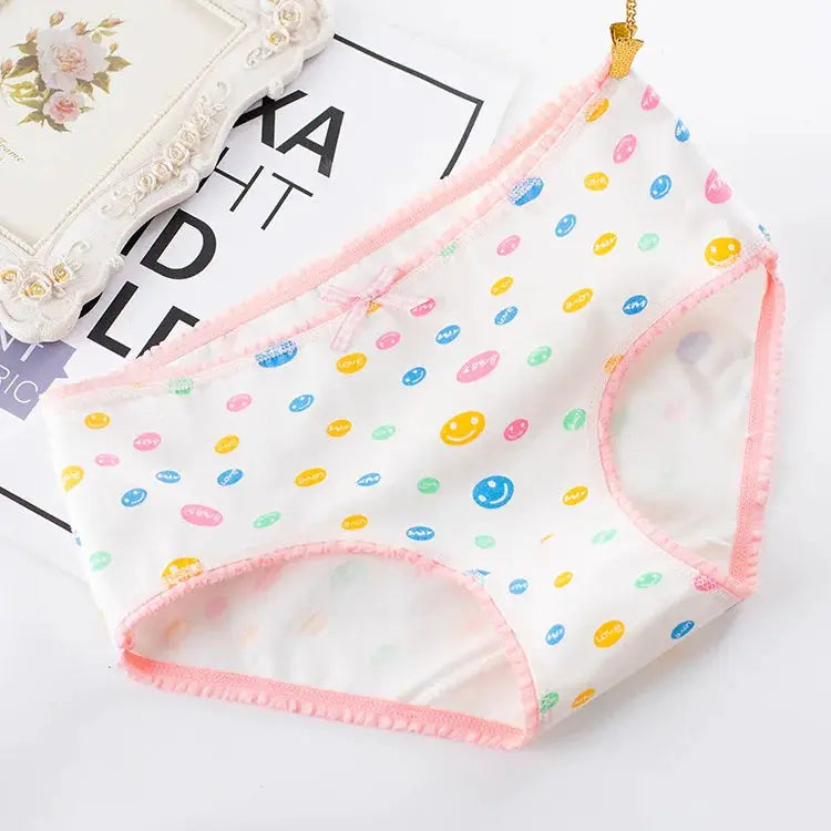 Women’s cotton seamless panties with pastel multicolor print, pink trim and bow detail.