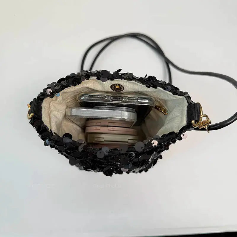 Simples Market LEFTSIDE mini sequins shoulder bag, black sequin crossbody with beige lining, open to reveal a phone inside