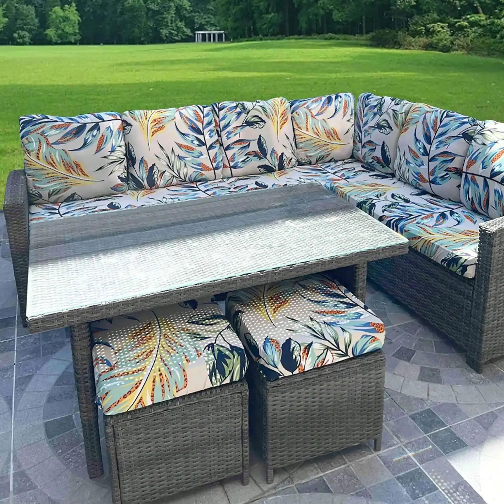 Outdoor tropical leaf print sofa cushions by Simples Market on a wicker sectional