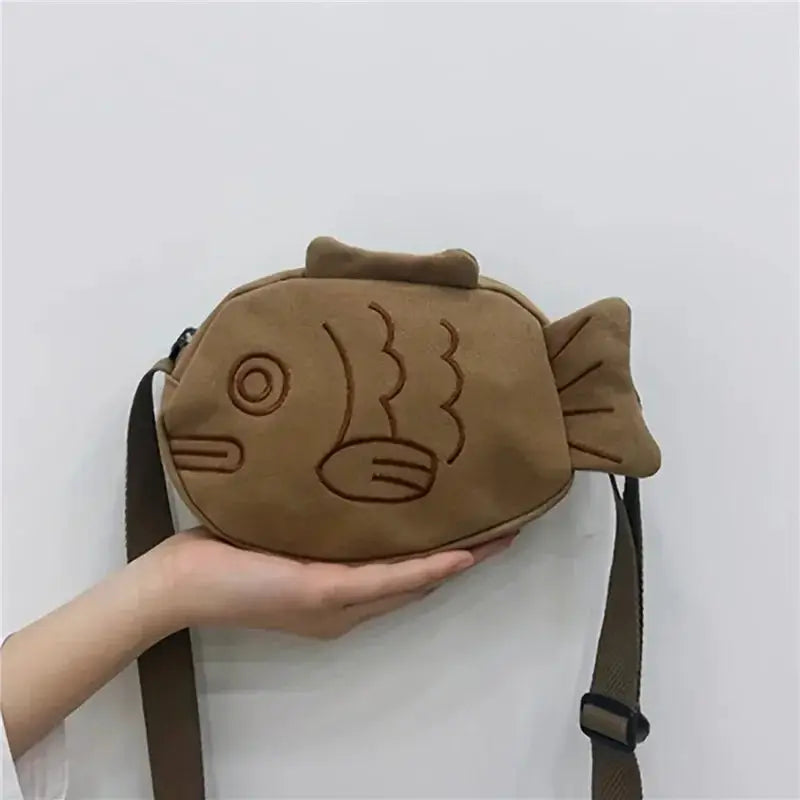 Fish-shaped brown canvas crossbody bag with embroidered fish design, small zippered purse